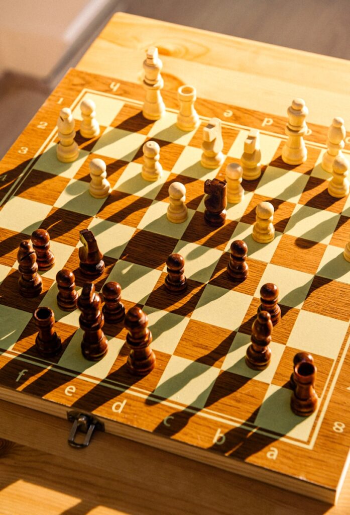 a wooden chess board with chess pieces on it